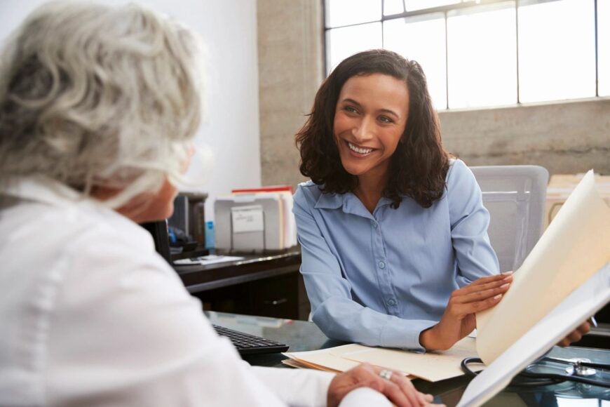 Two business professionals shaking hands, symbolizing a partnership between a small business owner and a professional bookkeeper from Emerald Consulting Inc.